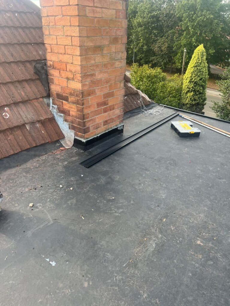 This is a photo of a flat roof which has just been repaired, there is also a chimney stack and some leadwork has also been dressed. Works carried out by LS Roofing Chinnor